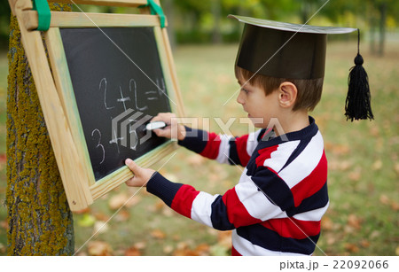 little happy boy writing on blackboard little happy boy writing on blackboard 22092066