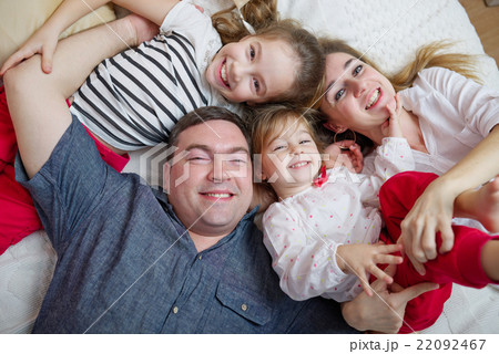 happy young family lying in bed 22092467