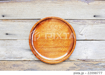 brown wooden plate on wooden table brown wooden plate on wooden table 22098777