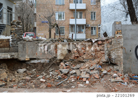 heap of broken red brick wall around  house 22101269