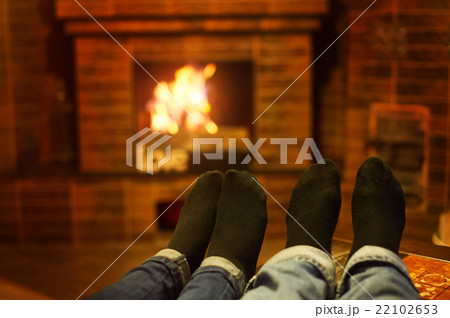 male and female legs near the fireplace. Family 22102653
