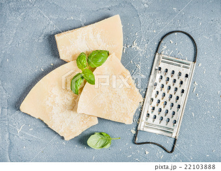 Cuts of Parmesan cheese with metal grater and Cuts of Parmesan cheese with metal grater and 22103888