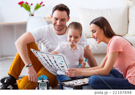 Couple  playing on the floor with his daughter  22107698