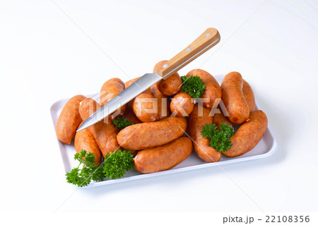 Pile of pork sausages on plate 22108356