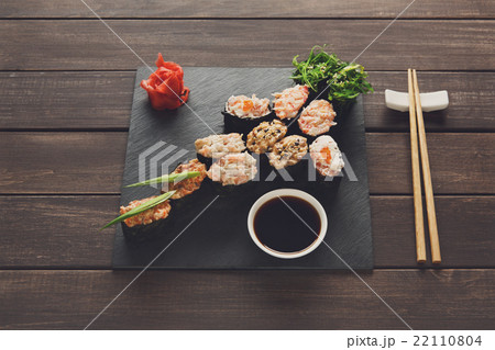 Set of sushi maki and rolls at black rustic wood. 22110804