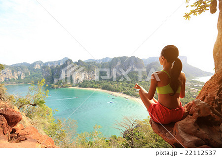 young healthy woman practice yoga on mountain peak rock young healthy woman practice yoga on mountain peak rock 22112537