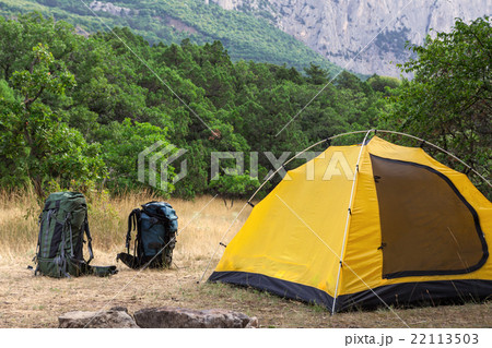 Two backpacks and tent on meadow Two backpacks and tent on meadow 22113503