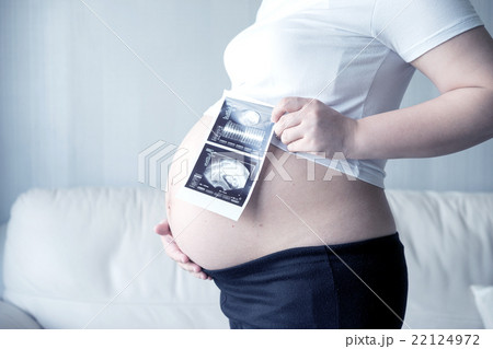 Pregnant woman with ultrasound scan picture Pregnant woman with ultrasound scan picture 22124972
