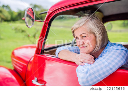 Close up of senior woman inside vintage pickup Close up of senior woman inside vintage pickup 22125656