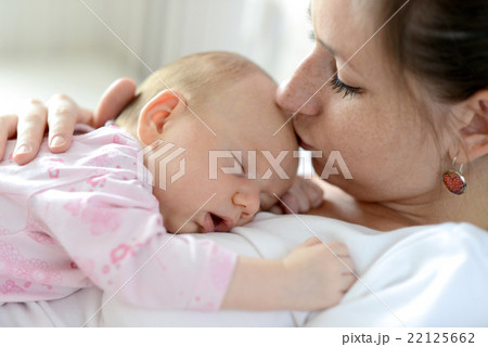 Close up of mother holding her cute baby daughter Close up of mother holding her cute baby daughter 22125662