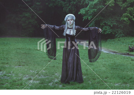 Blond girl with beautiful hair stands in the park. Blond girl with beautiful hair stands in the park. 22126019