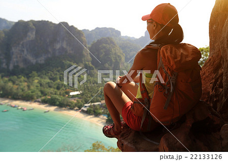 woman hiker enjoy the view on sunset seaside 22133126