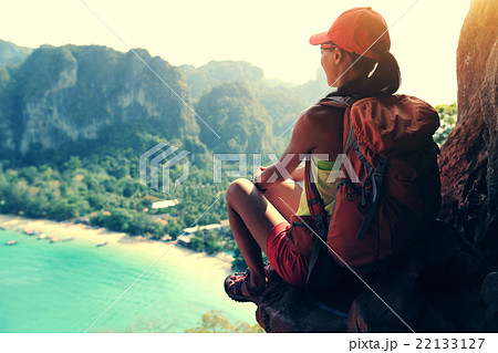 woman hiker enjoy the view on sunset seaside 22133127
