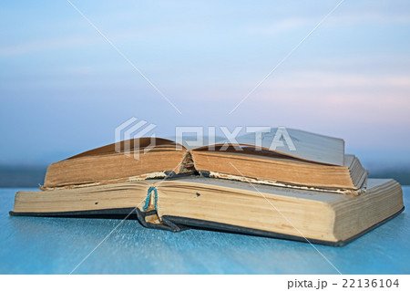Open books on the wooden blue table Open books on the wooden blue table 22136104
