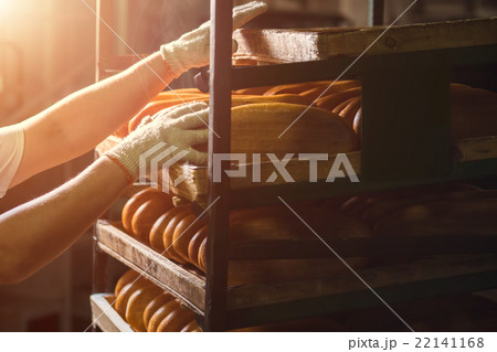 Hand touching shelves with bread. Hand touching shelves with bread. 22141168