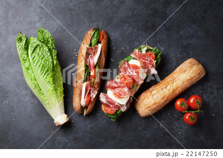 Sandwich with salad, prosciutto and mozzarella 22147250