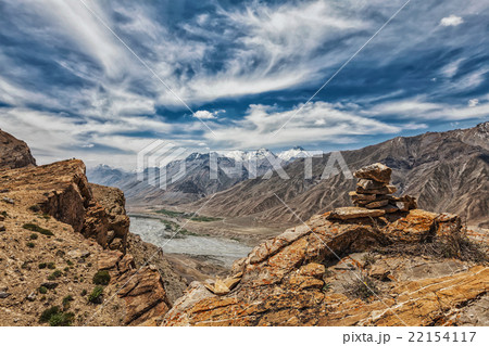 View of valley in Himalayas with stone cairn on 22154117