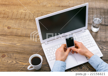 Top view of objects and hands on table 22156821