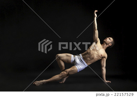 young man dancing over black 22157529