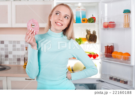 Young blonde at home near fridge Young blonde at home near fridge 22160188