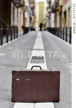 old suitcase in the middle of the street 22173710