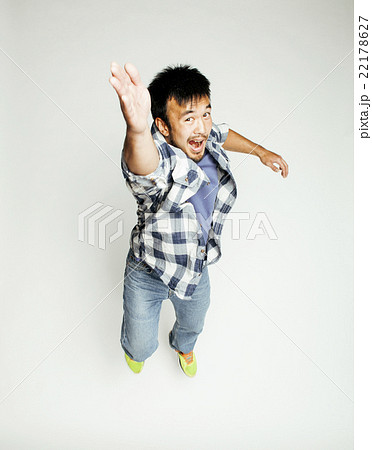 young pretty asian man jumping cheerful against young pretty asian man jumping cheerful against 22178627