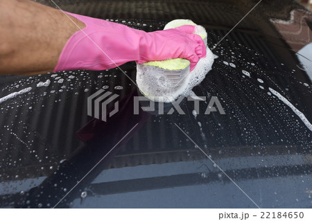 Hand hold sponge over the car for washing 22184650