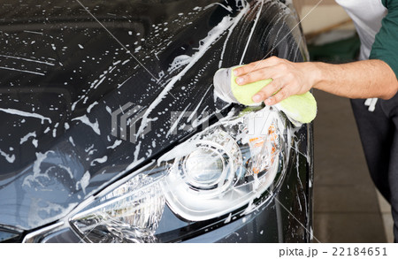 hand hold sponge over the car for washing 22184651