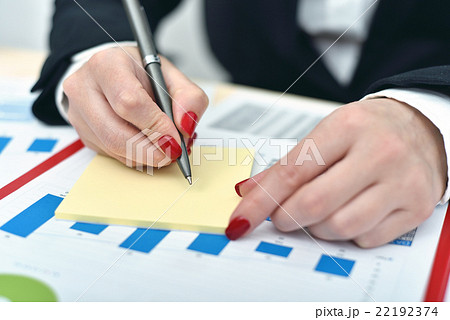 woman taking notes on paper woman taking notes on paper 22192374