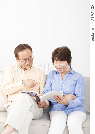 通販カタログを一緒に見るシニア夫婦 22192608