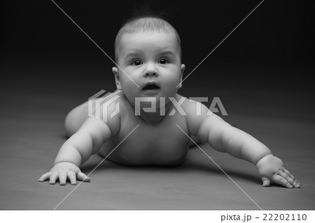 Beautiful baby on a black background 22202110