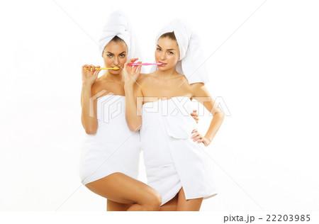 Two girls brush their teeth after shower 22203985
