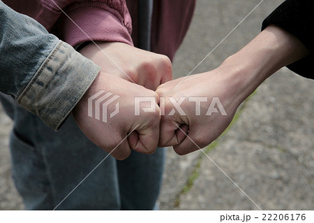 グータッチ三人男性の手の写真素材
