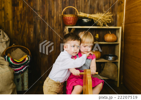 Children riding on a wooden horse Children riding on a wooden horse 22207519