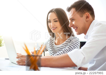 Delighted colleagues working on the laptop Delighted colleagues working on the laptop 22207991
