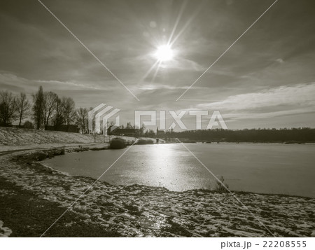 Winter pond with sun in vintage style 22208555