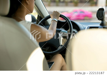 Woman with cell phone on her lap while driving 22213187