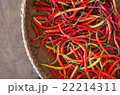 Several red and green hot chili peppers in basket 22214311