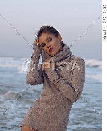 young pretty woman in sweater at seacoast walking 22214439