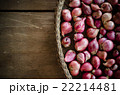 Several shallots in basket on wooden table 22214481