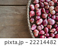 Several shallots in  basket on wooden table. 22214482