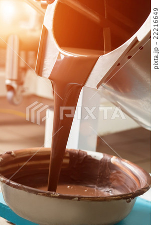 Tank pouring liquid into basin. 22216649