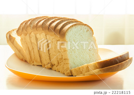 Loaf of white bread in a plate on a table 22218115