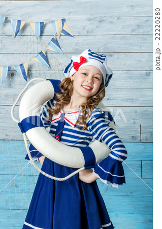 little girl holding a lifebuoy and laughing little girl holding a lifebuoy and laughing 22220280