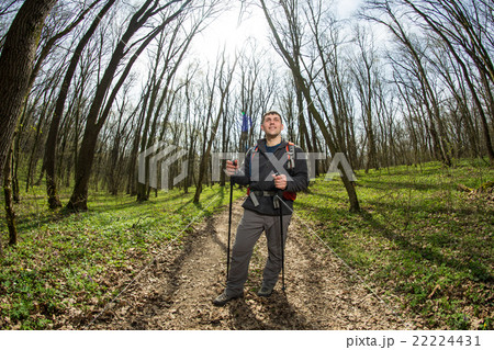 Male hiker looking to the side walking in forest 22224431