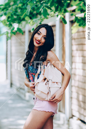 beautiful girl poses for camera in the city 22225690
