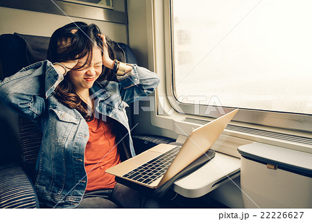 Asian girl frustrated with laptop on the train Asian girl frustrated with laptop on the train 22226627