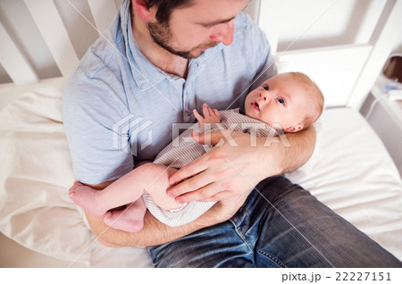 Young father holding his newborn baby son, home Young father holding his newborn baby son, home 22227151