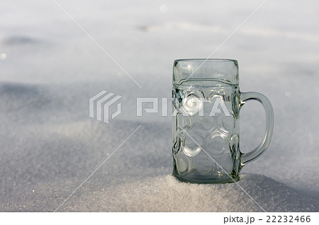 Glass mug in the snow 22232466