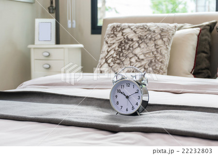 classical alarm clock on bed 22232803